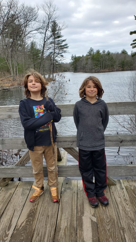 The twins pose in front of the pond at Harold Parker State forest.